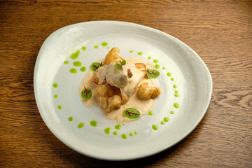 Chicken breast fillet with white sauce and olive oil