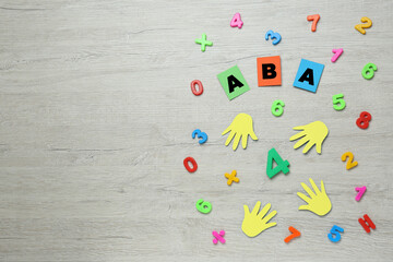 Flat lay composition with abbreviation ABA (Applied behavior analysis) and colorful numbers on...