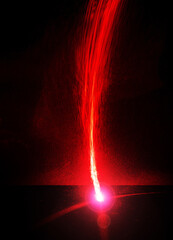 Fire trail and simulated meteorite impact using laser beams.