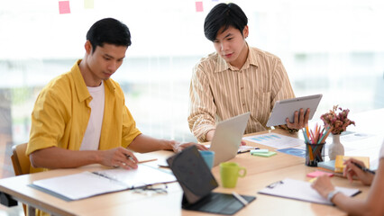 Asian young male employees working on the project together