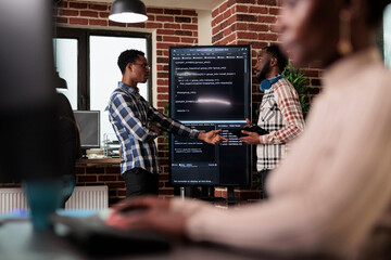 African american software developer pointing out cloud database processing algorithm error....