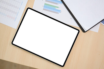 Top view, Digital tablet touchpad white screen mockup on the office desk.