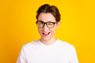 Photo of young handsome man good mood wink eye flirty date wear casual clothes isolated over yellow...