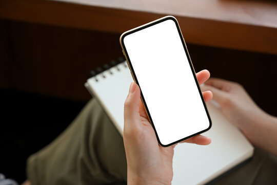 Female freelancer searching her inspirations on smartphone.