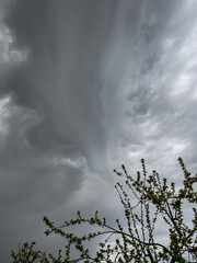 Clouds photography. Dark shelf storm clouds are above the house during a spring thunderstorm. Dangerous weather events.