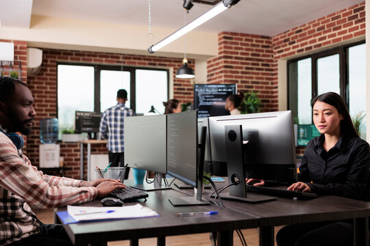 Software developer team programming encryption applications to be used as security measure. Diverse cybernetics engineers upgrading processing system application database.