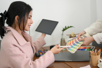 Female graphic design working at her office desk