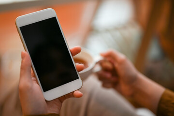 A woman scrolling on online shopping application.