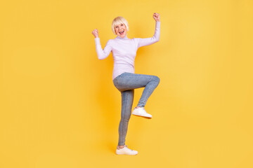 Fototapeta na wymiar Full body photo of excited senior lady good mood rejoice victory success triumph isolated over yellow color background