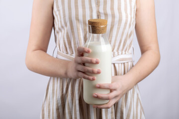 woman holding bottle of milk