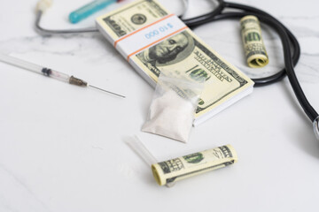 high costs of expensive medication concept , money and stethoscope.