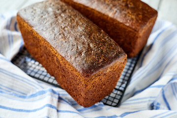 Freshly baked homemade rye bread on a textile background. Close-up, selective focus