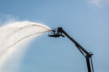 Firefighting equipment, a fire truck extinguishes a fire from a lift, at a height.