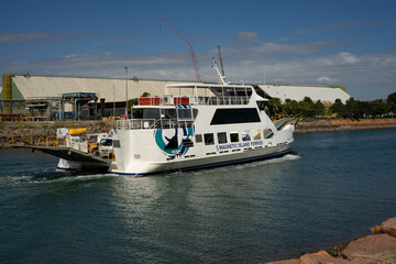 A Sealink Magnetic Island ferry cruising along the Ross River to the wharf in Townsville past large...