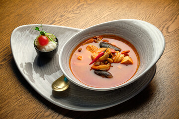 Mediterranean cuisine. Mussel soup with tomatoes and herbs