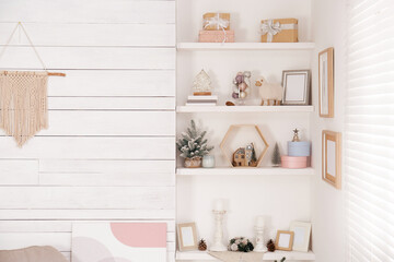 Wall shelves with beautiful Christmas decor indoors. Interior design