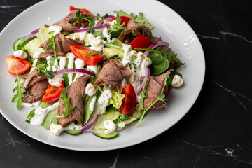 Beef tongue salad with fresh vegetables. Serving food in a restaurant. Photo for the menu