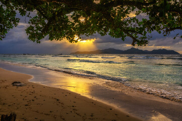 Sunset over Praslin Island seen from Anse Severe Beach at the La Digue Island, Seychelles
