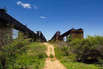 Fototapeta na wymiar Two rail bridges over the Burdekin River at Dotswood, Queensland, Australia, with the old heritage listed Macrossan Bridge on the right and its new replacement on the left.