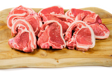 Fresh lamb chops on wooden cutting board and white background. Meat industry product. Butcher craft.