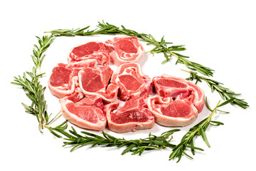 Nine fresh lamb chops in a shape of heart and framed by green rosemary herb on white background. Meat industry product.