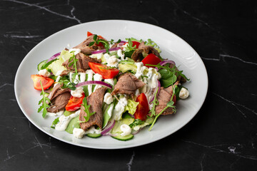Beef tongue salad with fresh vegetables. Serving food in a restaurant. Photo for the menu