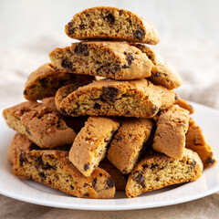 Homemade Italian Cantuccini with Chocolate on a White Plate, low angle view. Crispy Chocolate Cookies. Close-up.