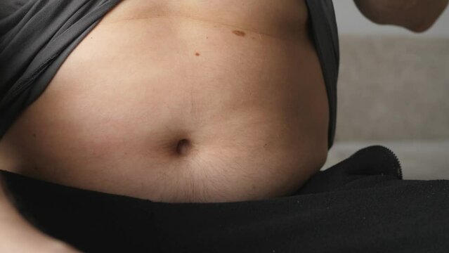 obese fat man showing belly abdomen