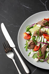 Beef tongue salad with fresh vegetables. Serving food in a restaurant. Photo for the menu
