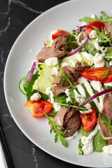 Beef tongue salad with fresh vegetables. Serving food in a restaurant. Photo for the menu