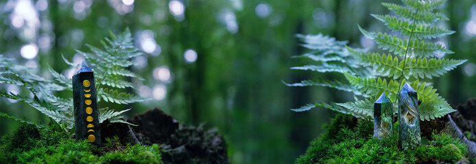 Crystals quartz towers on moss in  forest, natural green background. Minerals for healing magic...