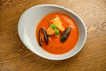 Mediterranean cuisine. Mussel soup with tomatoes and herbs