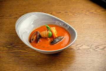Mediterranean cuisine. Mussel soup with tomatoes and herbs