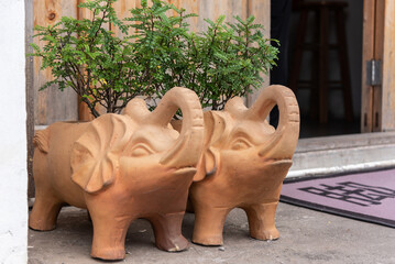 A pair of elephant-shaped stone sculptures at the door of the house. 