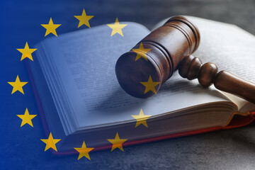 Double exposure of European union flag and book with wooden gavel on grey table - obrazy, fototapety, plakaty