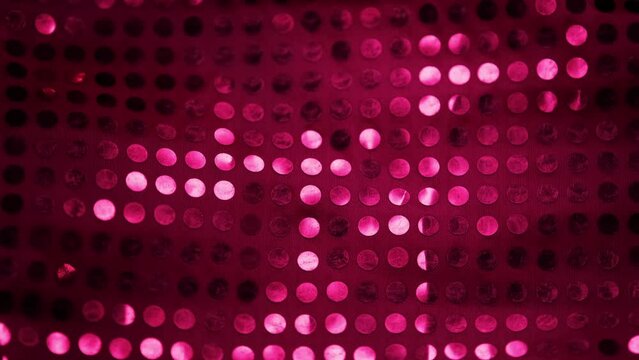 Red sequin fabric shining under light
