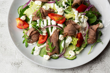 Beef tongue salad with fresh vegetables. Serving food in a restaurant. Photo for the menu