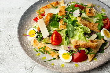 French salad Nicoise with tuna, egg, green beans, tomatoes, olives, lettuce, onions and anchovies on a white background. Healthy food