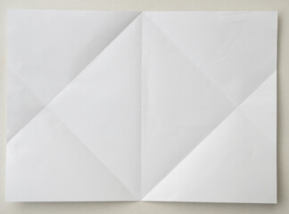 White folded and wrinkled paper on white background