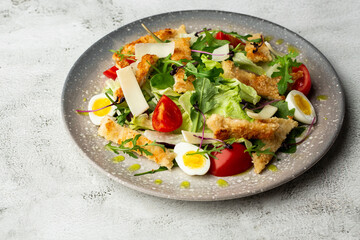 French salad Nicoise with tuna, egg, green beans, tomatoes, olives, lettuce, onions and anchovies on a white background. Healthy food