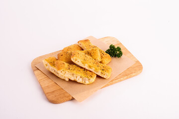 Homemade garlic bread on the wooden plate.
