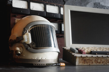Concept of astronaut helmet and blank screen computer monitor with copy space on the table of the...