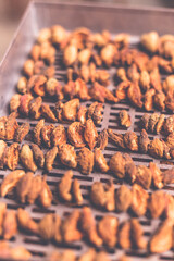 The process of home cooking dried fruits in an electric dryer.