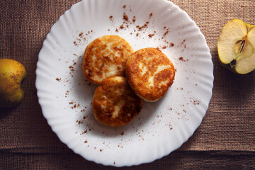 brown cheese cakes on the white plate