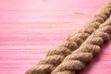 Mooring rope on the pink close up background with copy space.