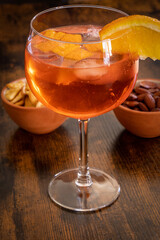 spritz cocktail on a table with appetizer cakes