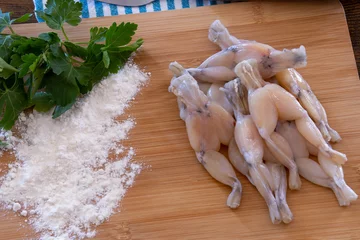 Tafelkleed fresh raw frog legs with parsley and flour on wooden board, French cuisine  © ALF photo
