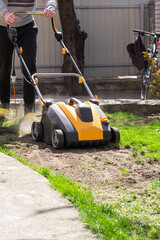 Electric Lawn scarifier. Work on green grass