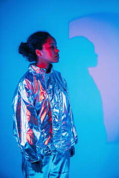 Woman standing in front of wall with shadow