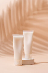 Cream tube mockup for branding presentation. Natural skincare beauty product on square white podium. Natural earthy colors